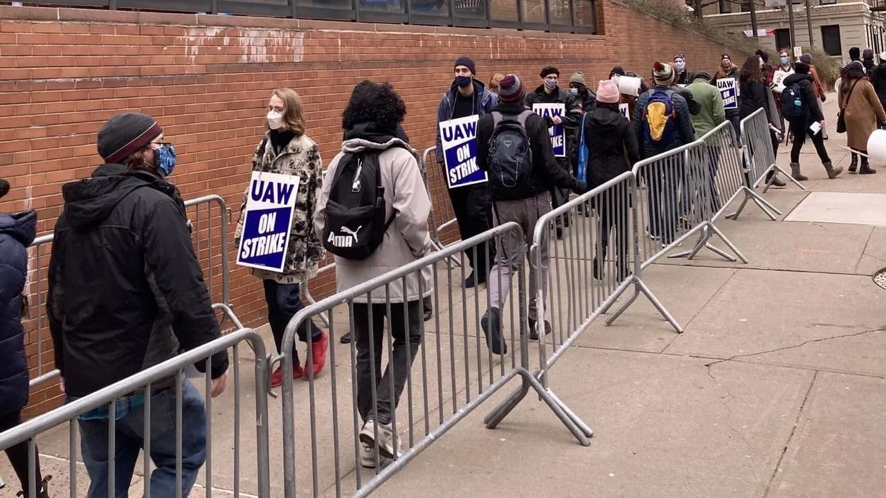 Columbia graduate students on a picket line holding “UAW On Strike” signs during the 2020–2021 strike